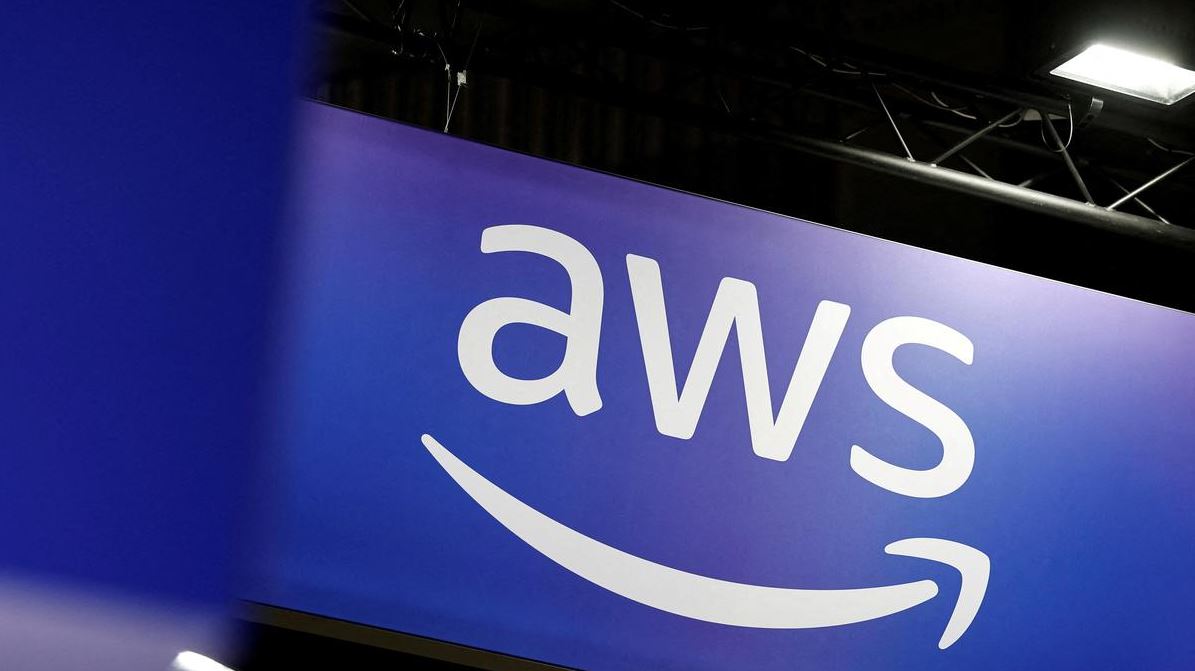 Close-up of AWS logo on a screen with a smartphone keyboard overlay and visual distortion, symbolizing disruption to Amazon cloud services and digital infrastructure