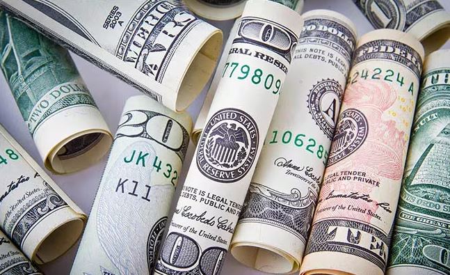 Rolled US dollar bills symbolizing wealth inequality and economic power
