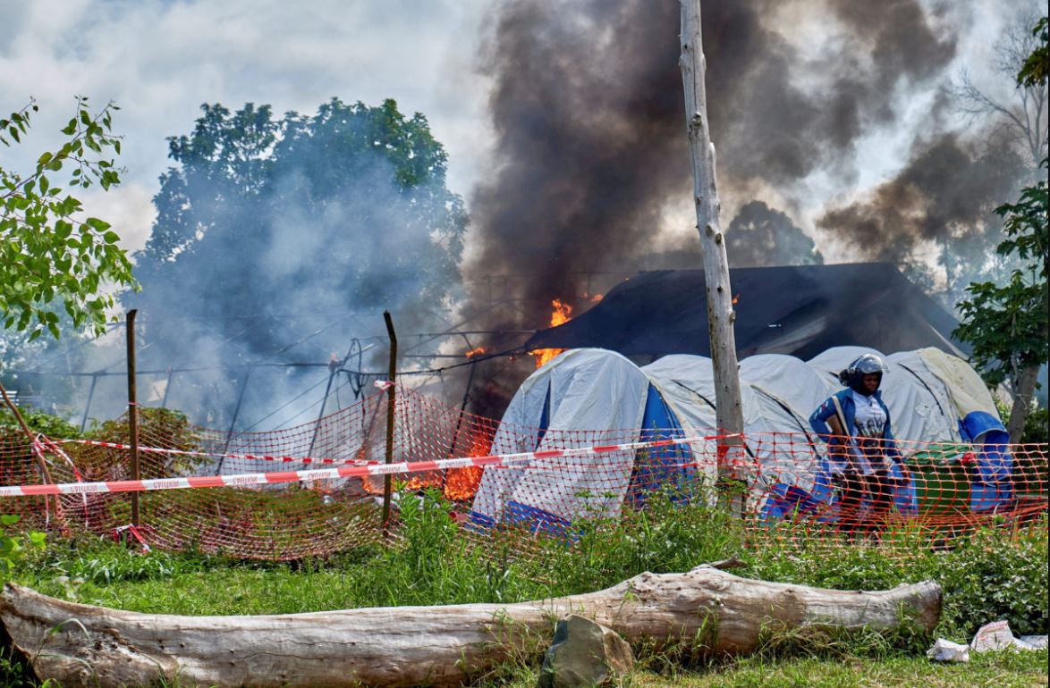 Burning Ebola treatment tents in Rwampara, eastern Congo, after residents clashed with authorities over Ebola burial protocols during the Bundibugyo outbreak