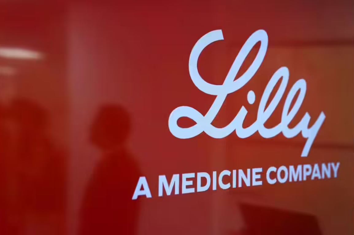 Eli Lilly company logo displayed on a red office wall during the announcement of retatrutide obesity drug trial results