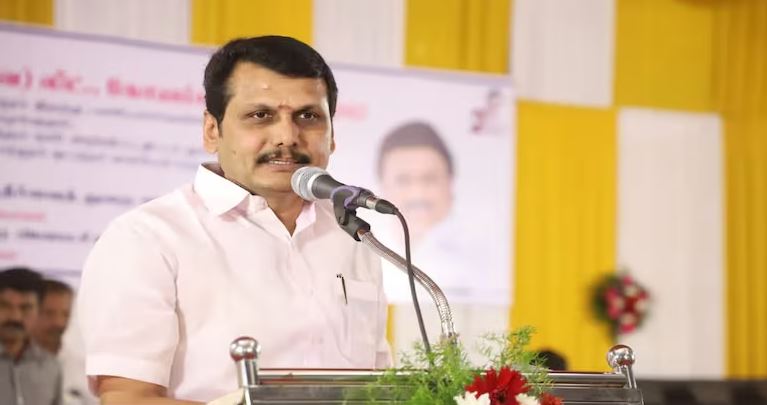 Former Tamil Nadu Minister V. Senthil Balaji speaking at a public event while addressing supporters from a podium.