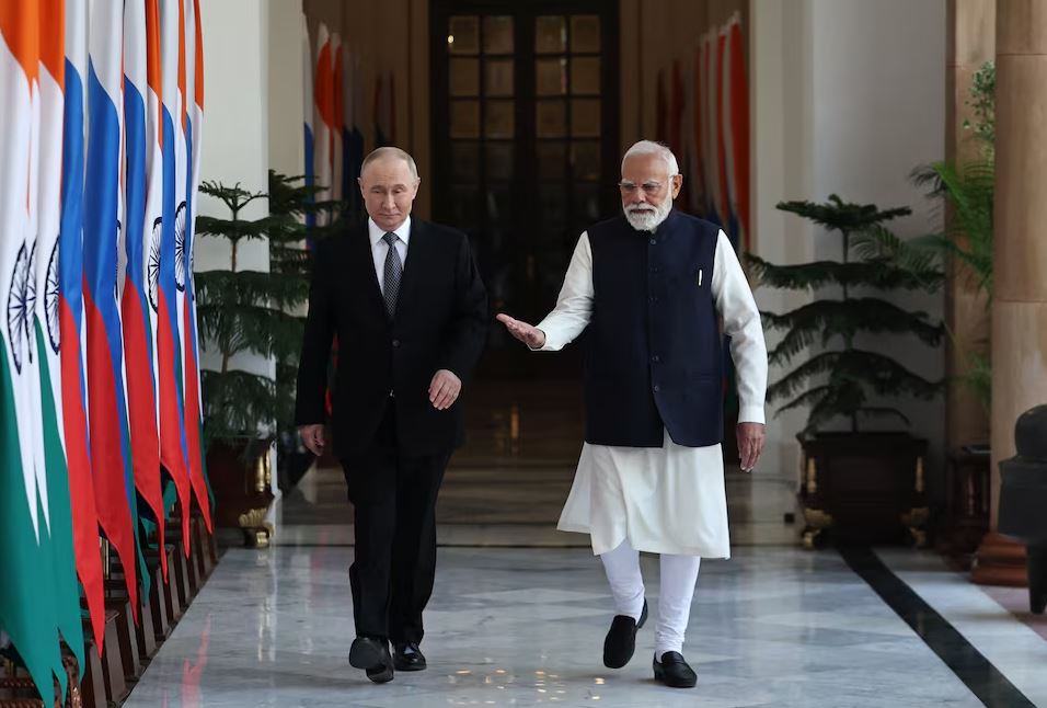 Vladimir Putin and Narendra Modi walk together during an official India-Russia meeting.