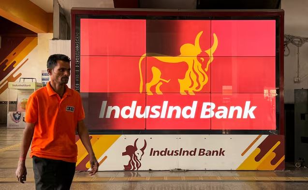 IndusInd Bank branch display with logo and customer walking past in India