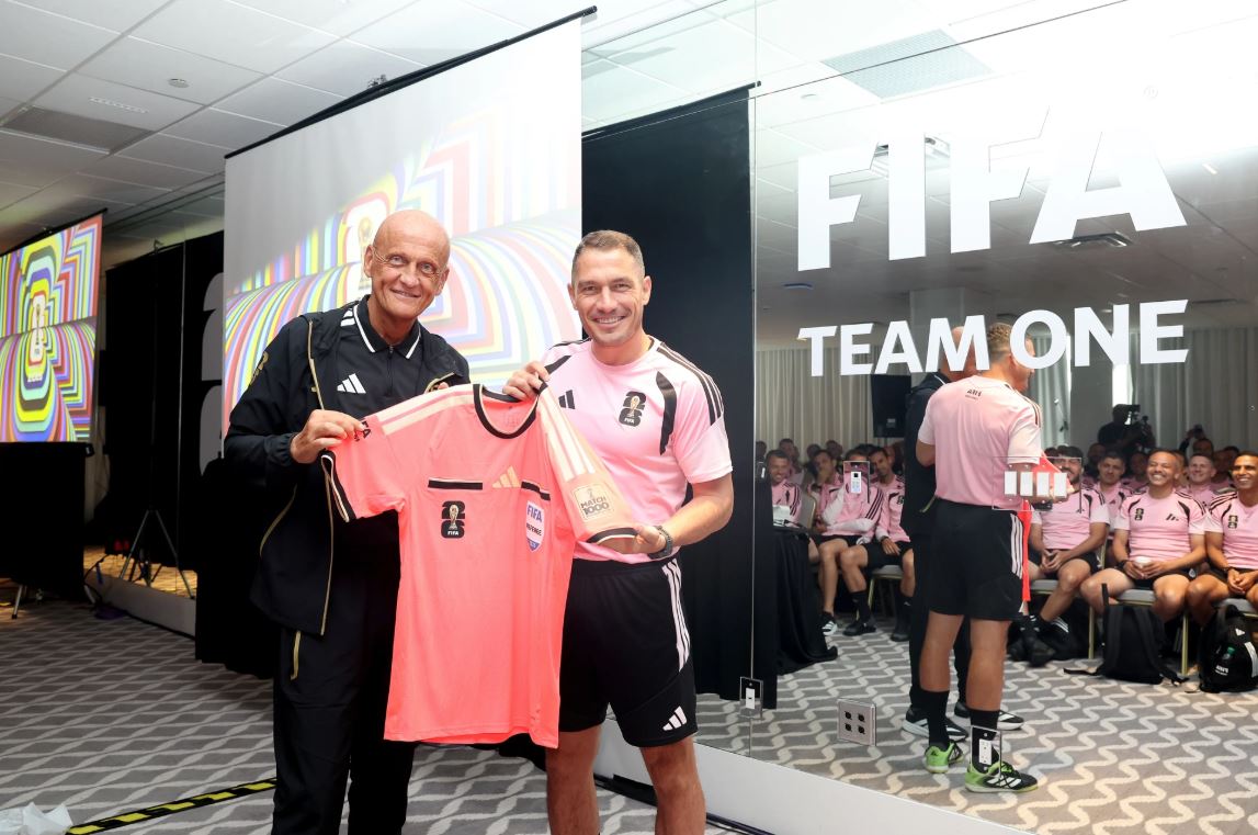 István Kovács holds the commemorative Match 1000 referee jersey presented by FIFA.