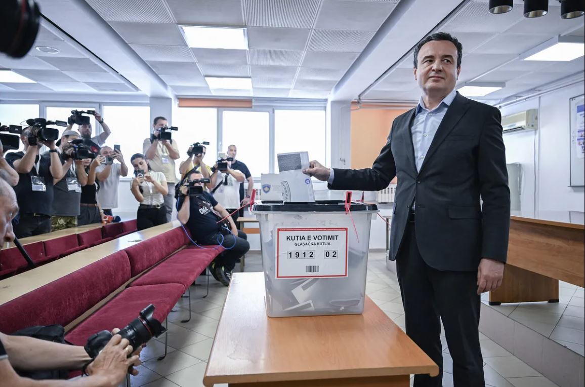 Kosovo Prime Minister Albin Kurti casts his vote during the Kosovo Election 2026 as media observe the polling process