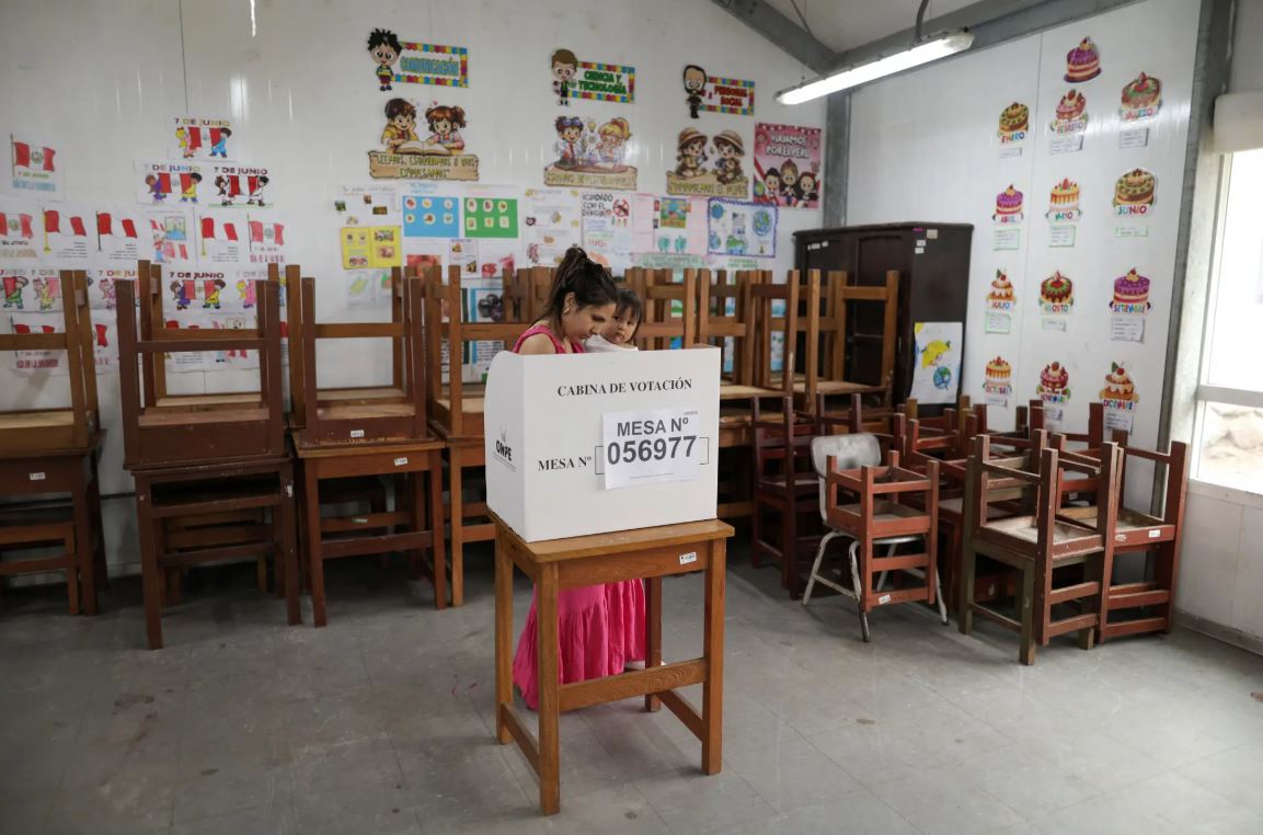 Voter casts a ballot at a polling station during Peru's 2026 presidential runoff election