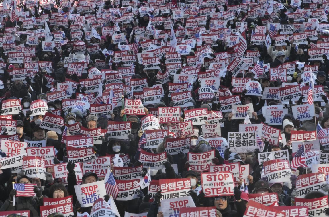 Crowd of protesters holding Stop the Steal signs at a South Korea election rally amid election fraud claims and political controversy