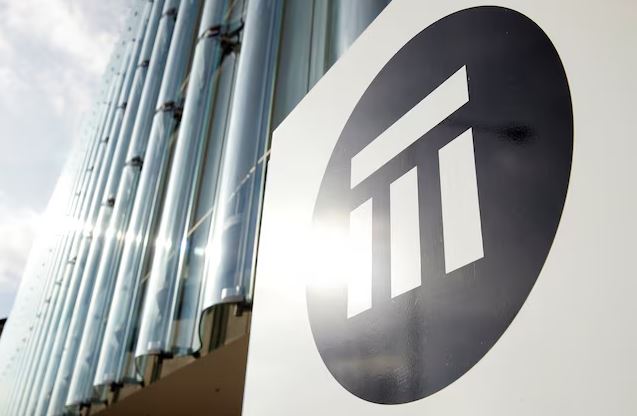 Swiss Re company logo displayed outside a modern corporate office building representing global insurance and reinsurance industry risk analysis.