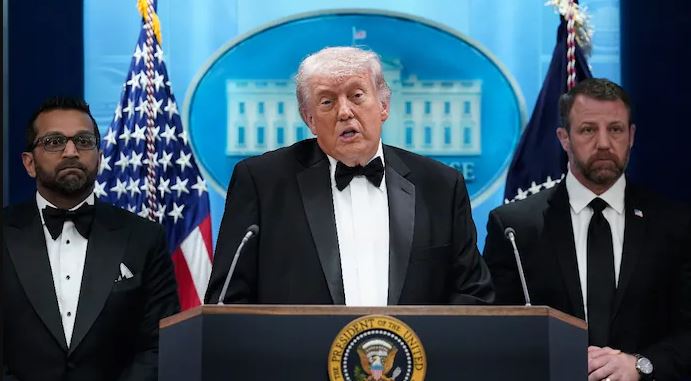 Donald Trump addresses press after dinner attack as officials stand beside him at White House briefing