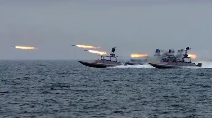 Fast attack boats launch rockets during a naval operation in the Strait of Hormuz amid escalating US-Iran military tensions.