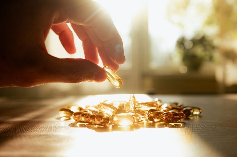 Vitamin D supplements in sunlight representing cancer treatment support