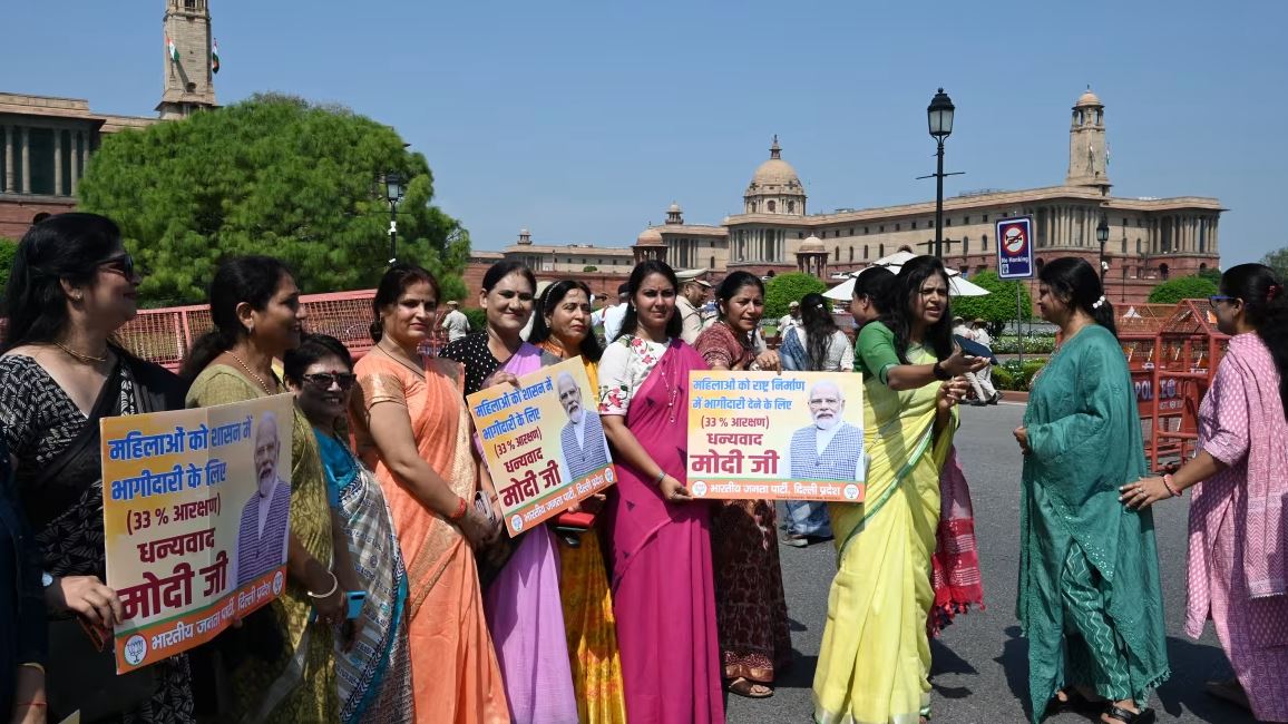 Women holding placards supporting the 33% Women’s Reservation Bill outside India’s Parliament in New Delhi
